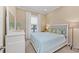 Well lit bedroom with a large window and neutral decor with pops of blue at 315 Sapphire Lake Dr # 101, Bradenton, FL 34209