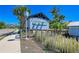 Charming entrance to Mangrove Walk highlighted by tropical landscaping and clear signage at 315 Sapphire Lake Dr # 101, Bradenton, FL 34209