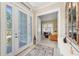 Bright foyer featuring tile flooring, a decorative mirror, and a view into the adjacent living area at 315 Sapphire Lake Dr # 101, Bradenton, FL 34209