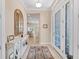 Bright entryway with stylish decor, tile flooring, and an inviting view into the living room at 315 Sapphire Lake Dr # 101, Bradenton, FL 34209