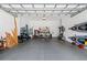 Spacious garage with storage racks and tools, offering ample space for parking and organization at 315 Sapphire Lake Dr # 101, Bradenton, FL 34209