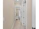 Hallway view of bedroom and ensuite bathroom with tile flooring at 315 Sapphire Lake Dr # 101, Bradenton, FL 34209