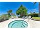 Inviting hot tub with lounge chairs and shade trees overlooking the serene waterfront at 315 Sapphire Lake Dr # 101, Bradenton, FL 34209