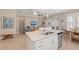 Open-concept kitchen with stainless steel appliances, island seating, and a view to the living room at 315 Sapphire Lake Dr # 101, Bradenton, FL 34209