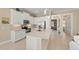 Bright white kitchen with stainless steel appliances and center island with counter seating at 315 Sapphire Lake Dr # 101, Bradenton, FL 34209