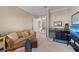 Bright living room offers a comfortable couch, ottoman and seamless transition to a living space with a built-in mini bar at 315 Sapphire Lake Dr # 101, Bradenton, FL 34209