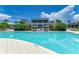 Beautiful outdoor pool with lounge chairs and umbrellas for relaxing by the water at 315 Sapphire Lake Dr # 101, Bradenton, FL 34209