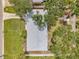 This aerial view captures a home with a gray roof surrounded by lush green trees and landscaping at 3153 Irving St, Sarasota, FL 34237