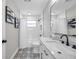 Modern bathroom featuring black and white patterned floor, white subway tiles, and updated vanity at 3153 Irving St, Sarasota, FL 34237