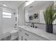 Stylish bathroom with white subway tiles, patterned floors, and a modern vanity with a large mirror at 3153 Irving St, Sarasota, FL 34237