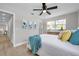 Bright bedroom with wood floors, light gray walls, blue accents, and a window providing natural light at 3153 Irving St, Sarasota, FL 34237