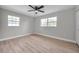 An empty bedroom featuring wood-look floors, light grey walls, and plenty of natural light at 3153 Irving St, Sarasota, FL 34237