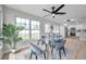 Well-lit dining area connected to a modern kitchen with hardwood floors, offering a cozy and inviting ambiance at 3153 Irving St, Sarasota, FL 34237