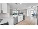 Open concept kitchen with island and stainless-steel dishwasher; view to the living and dining rooms at 3153 Irving St, Sarasota, FL 34237