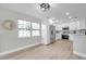 Modern kitchen with white cabinets, stainless steel appliances, lots of natural light, and hardwood floors at 3153 Irving St, Sarasota, FL 34237