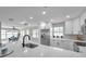 Beautiful white kitchen with stainless appliances and quartz countertops open to dining area at 3153 Irving St, Sarasota, FL 34237