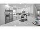 Beautiful kitchen featuring white cabinets, stainless appliances, and a quartz countertop with undermount sink at 3153 Irving St, Sarasota, FL 34237