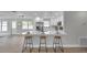Modern kitchen featuring a spacious island with seating, white cabinets, and stainless steel appliances at 3153 Irving St, Sarasota, FL 34237