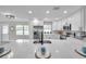Bright kitchen featuring white cabinets, stainless appliances, and a quartz countertop with undermount sink at 3153 Irving St, Sarasota, FL 34237