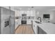 Bright kitchen with white cabinets, stainless appliances and a marble countertop with undermount sink at 3153 Irving St, Sarasota, FL 34237