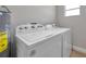 A laundry area with a washer, dryer, and an energy guide, with tile floors and natural light at 3153 Irving St, Sarasota, FL 34237