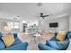 Spacious living area with an eat-in kitchen, breakfast bar seating, and stylish light fixtures at 3153 Irving St, Sarasota, FL 34237