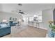 Bright, open-concept living room featuring modern light wood floors and a kitchen with stainless steel appliances at 3153 Irving St, Sarasota, FL 34237