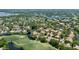 Scenic aerial view showcasing homes nestled amongst lush trees and sparkling lakes at 3362 Sandleheath # 12, Sarasota, FL 34235