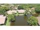 Aerial view of home backing to pond with mature trees, providing privacy and scenic views at 3362 Sandleheath # 12, Sarasota, FL 34235