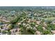 An aerial view showing a community surrounded by lush greenery and multiple waterways at 3362 Sandleheath # 12, Sarasota, FL 34235