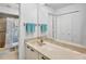 Bathroom featuring a large mirror, spacious vanity, walk-in shower and toilet at 3362 Sandleheath # 12, Sarasota, FL 34235