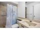 Bathroom featuring a large shower with a shower curtain, toilet and vanity at 3362 Sandleheath # 12, Sarasota, FL 34235