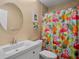 Bathroom featuring a mirror, toilet, and shower with a flamingo shower curtain at 3362 Sandleheath # 12, Sarasota, FL 34235