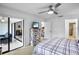 Bright bedroom with a sliding glass door, ceiling fan and white walls at 3362 Sandleheath # 12, Sarasota, FL 34235