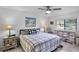 Bedroom with a checkered bedspread, neutral walls, and lots of natural light at 3362 Sandleheath # 12, Sarasota, FL 34235