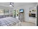 Bedroom with a checkered bedspread, dresser and access to the patio at 3362 Sandleheath # 12, Sarasota, FL 34235