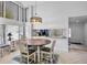 Dining area with a round wood table, stylish chandelier, and view into the kitchen at 3362 Sandleheath # 12, Sarasota, FL 34235