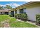 A clean single-story home exterior with a well-manicured lawn and bushes at 3362 Sandleheath # 12, Sarasota, FL 34235