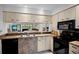 Kitchen with countertop seating and black appliances at 3362 Sandleheath # 12, Sarasota, FL 34235
