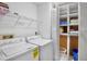 Bright laundry room featuring a washer and dryer and folding shelf at 3362 Sandleheath # 12, Sarasota, FL 34235