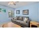 Living room with blue walls, tile floors, and a gray sofa at 3362 Sandleheath # 12, Sarasota, FL 34235
