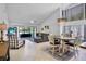 Open-concept living space with a vaulted ceiling, pond views, and seamless access to dining area at 3362 Sandleheath # 12, Sarasota, FL 34235