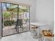 Outdoor patio seating with a dining table and a view of the yard at 3362 Sandleheath # 12, Sarasota, FL 34235