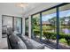 Inviting sunroom with pond views, large glass doors, and access to other rooms at 3362 Sandleheath # 12, Sarasota, FL 34235
