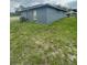 View of the backyard showcasing the house's exterior and the grassy area at 3622 N 51St St, Tampa, FL 33619