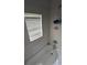 A tile-lined bathtub with a shower head and storage rack offers a relaxing bathing space at 3622 N 51St St, Tampa, FL 33619