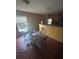 A dining area is featured next to the kitchen with a glass table and seating for four, near a bright window at 3622 N 51St St, Tampa, FL 33619