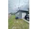 Exterior view of the side of the house with utilities, a garage, and a car in the driveway at 3622 N 51St St, Tampa, FL 33619