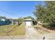 View of the home's exterior and front yard featuring a driveway leading up to a one-car garage and landscaping at 3622 N 51St St, Tampa, FL 33619