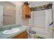 A bathroom featuring wallpaper, oak cabinets, a single sink, toilet, bathtub and unique fixtures at 3818 Chris Dr, Wesley Chapel, FL 33543